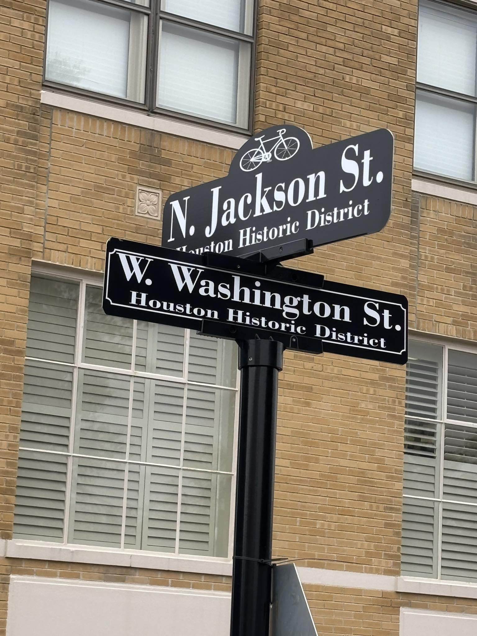 Illuminated storefront business sign with company logo and branding